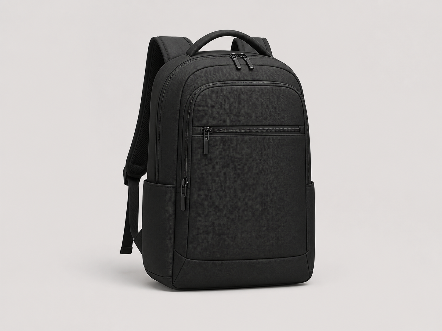Minimal all-black everyday backpack on a light studio background